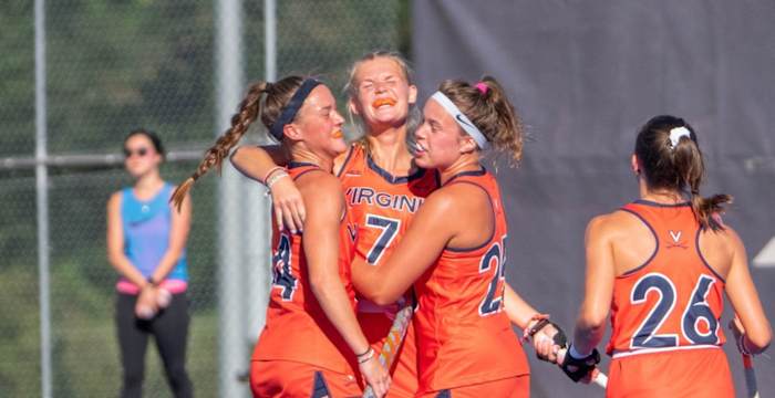 Cato Geusgens celebrates with her team after scoring a goal for the Virginia field hockey team against Syracuse.